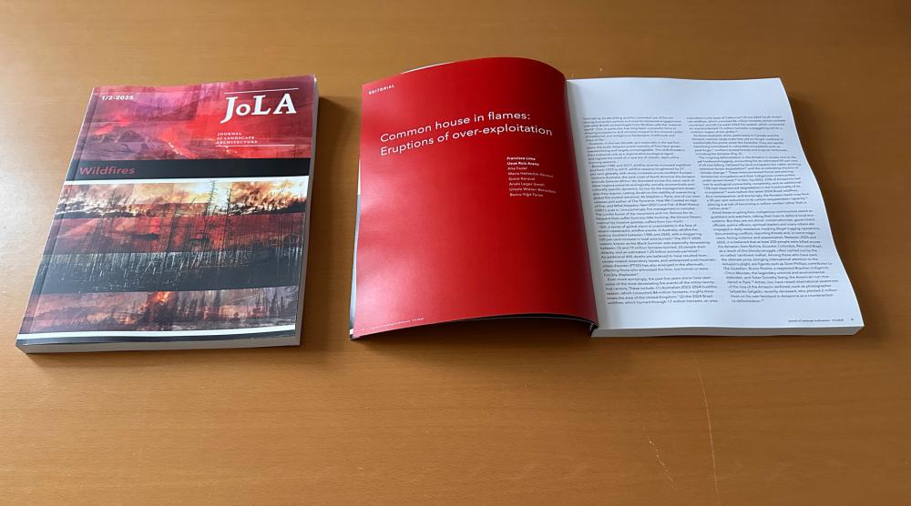 Two architecture journals, one closed and one open at the first page, lying flat on a table.