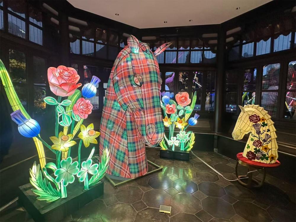 Four lanterns are on display. They look like two bunches of daffodils, roses and thistles; a small horses head with the same flowers on its side; and a large tartan horses head.