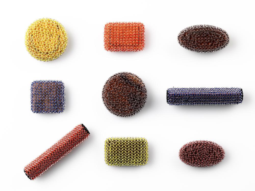 Series of colourful beaded brooches in simple forms. Arranged in a grid formation, their bright juicy colours pop against a white background. 