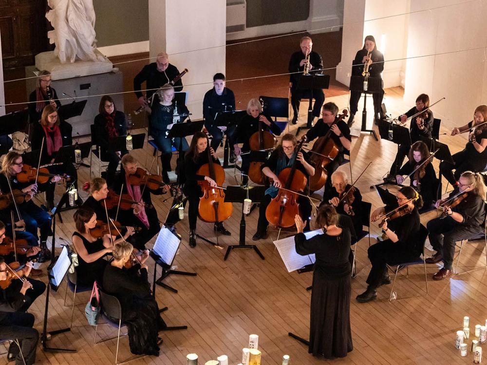 The orchestra playing, shot from above.