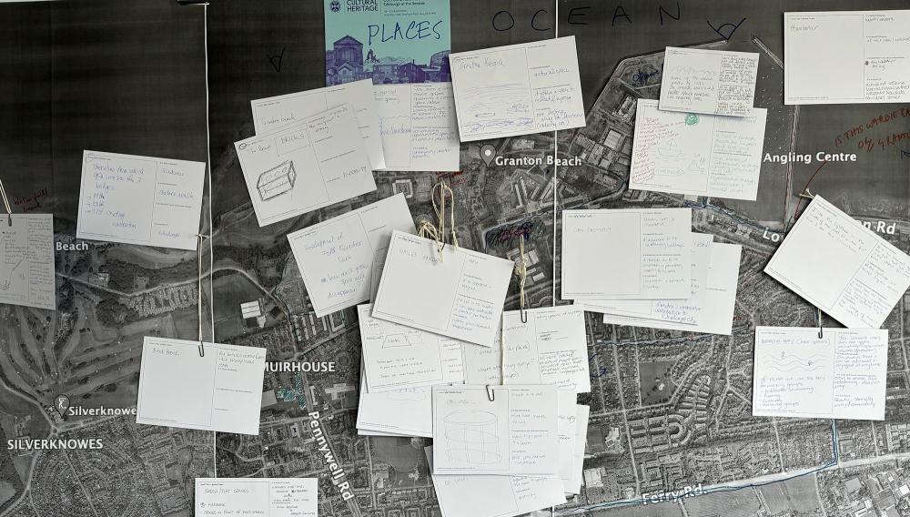 A map of North Edinburgh with notecards lain on top of it with writing on them.