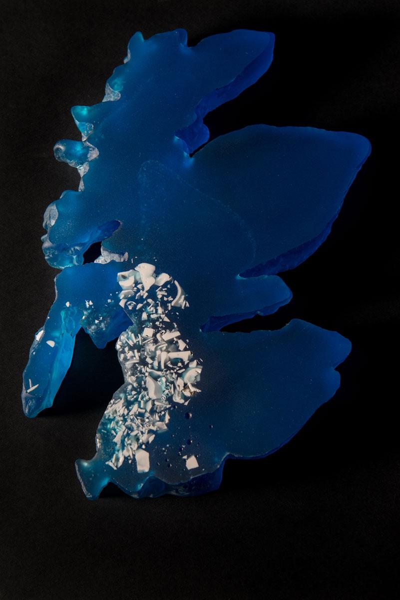 A glass piece by Jessamy Kelly depicting Scotland in blue glass with white pieces on the south west side of the country.