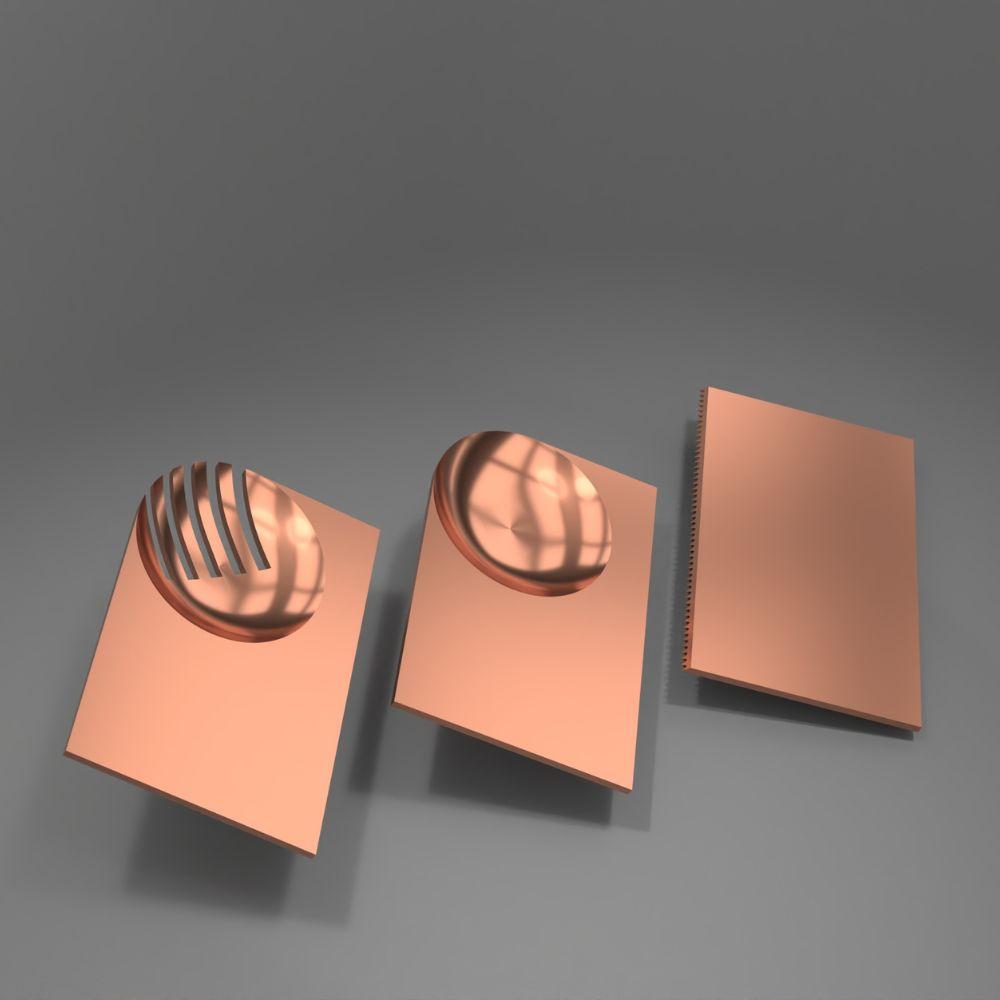 Three copper-coloured sheets of metal, the size of credit cards. Two of them have circular bowl shapes in the corner, one of which is cut into fork tines, the other uncut to be used as a spoon.