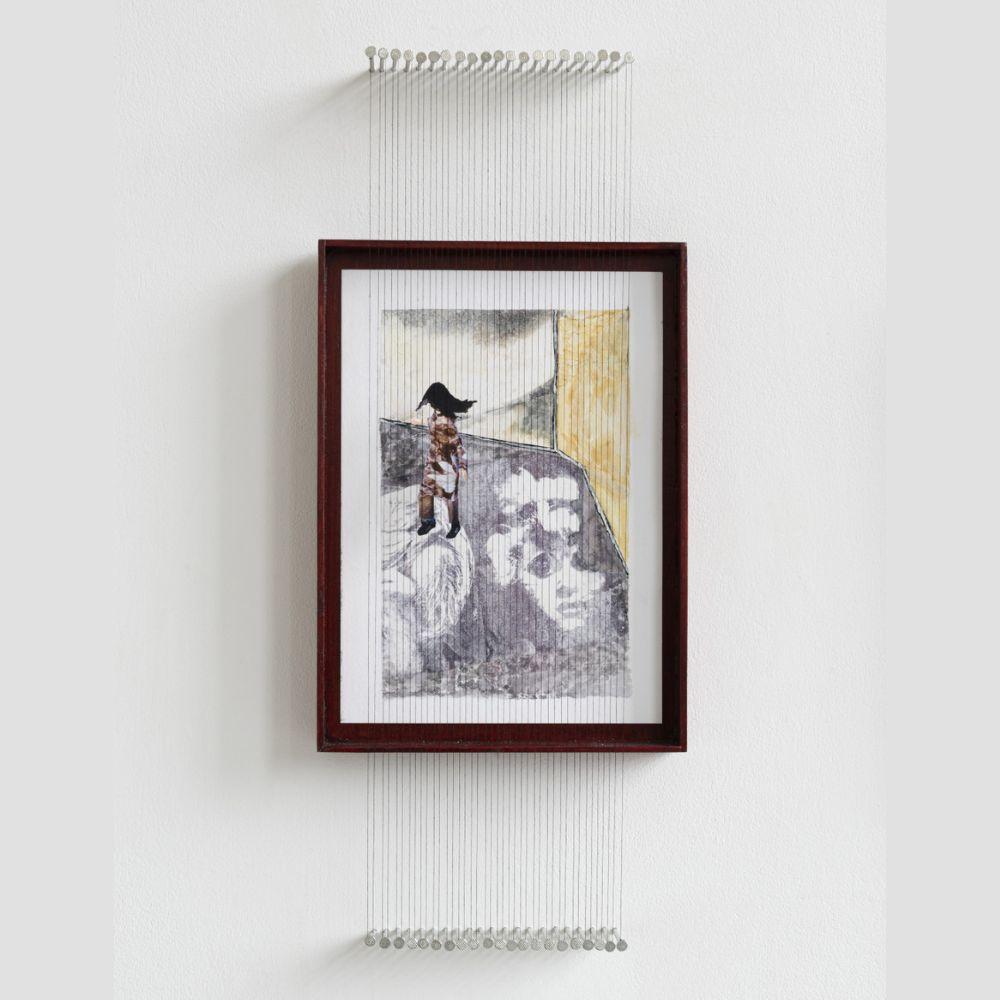 A painting in a frame on a white wall - a wide-eyed face on what appears to be the floor; a walking figure with a shock of long black hair. Suspended in front of the frame are lines of threads or wires, pulled taut around two rows of nails, one row above the frame, and one below, parallel to the frame edges.